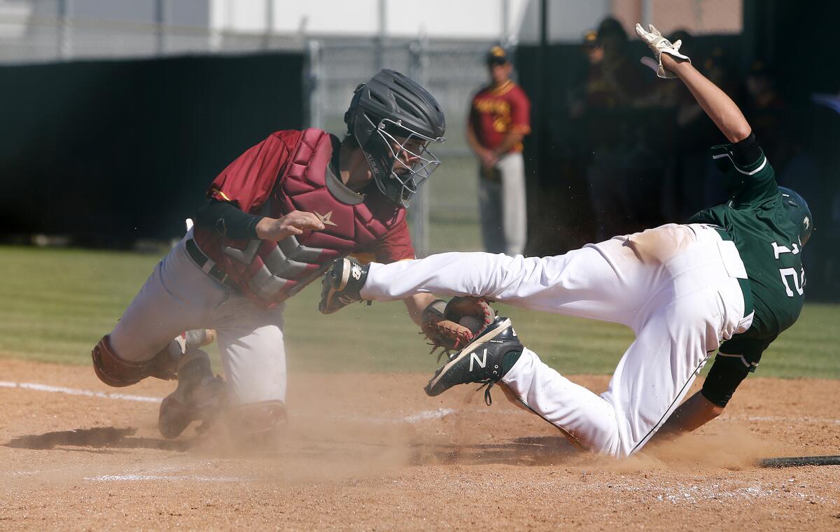 Estancia catcher Blake Peck, left, makes the tag at home plate against Costa Mesa's Sam Stute during the fourth inning.