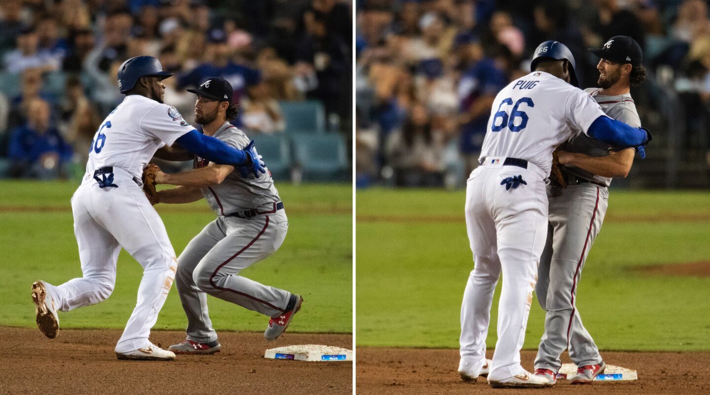 Dodgers right fielder Yasiel Puig seems to hug Atlanta Braves shortstop Charlie Culberson after being tagged out attempting to steal second base in the 6th inning.