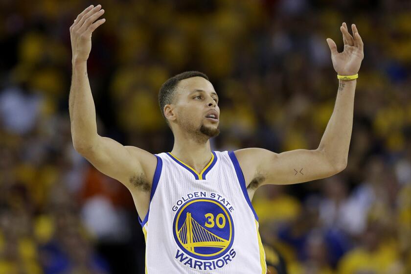 Golden State Warriors guard Stephen Curry gestures after scoring against the Cleveland Cavaliers during the second half of Game 7 of the NBA Finals.