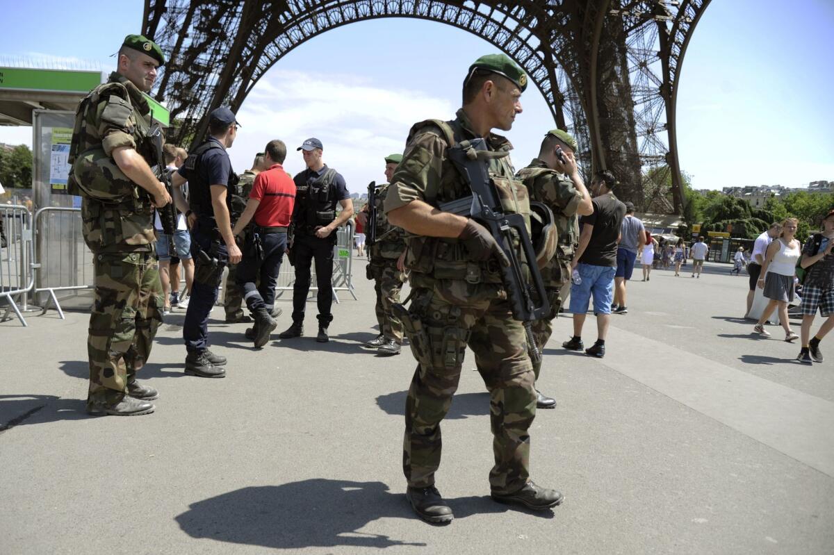 Soldiers patrol under the Eiffel Tower in Paris as part of the Vigipirate security alert system on June 26. Earlier that day, a factory in the Rhone-Alpes region was hit in an attack defined as "Islamist terrorism" by the French prime minister.