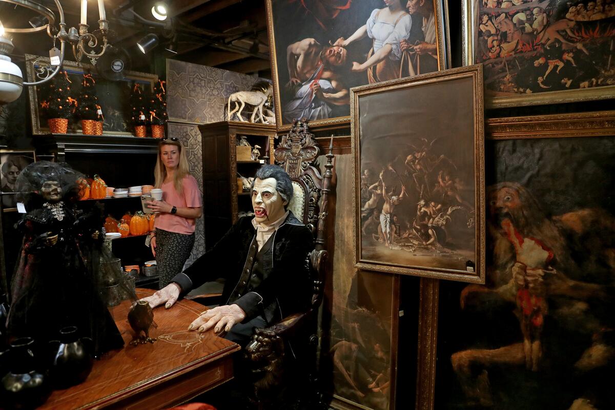 A shopper browses through the Dracula room of "Cabinet of Curiosities," at Roger's Gardens in Corona del Mar.