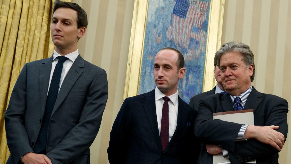 Jared Kushner, Stephen Miller and Stephen Bannon stand together in the Oval Office of the White House last month.