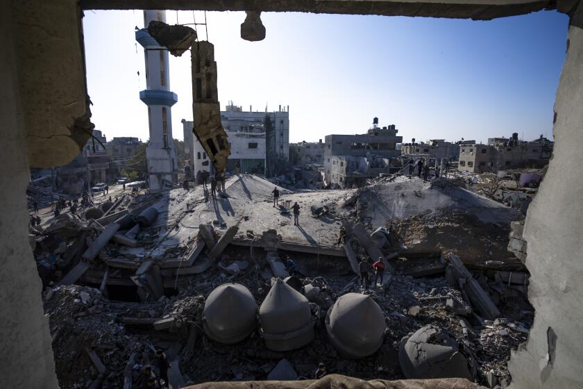 Palestinians look at the destruction after an Israeli strike on residential buildings and a mosque in Rafah, Gaza Strip, Thursday, Feb. 22, 2024. (AP Photo/Fatima Shbair)