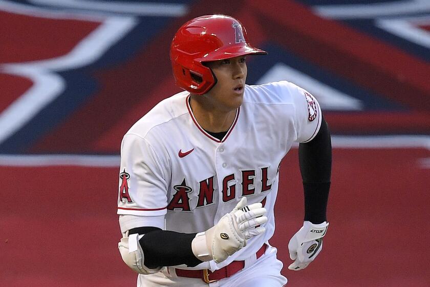 Los Angeles Angels' Shohei Ohtani, of Japan, runs to first as he pops out during the first inning of a baseball game against the Seattle Mariners Wednesday, July 29, 2020, in Anaheim, Calif. (AP Photo/Mark J. Terrill)