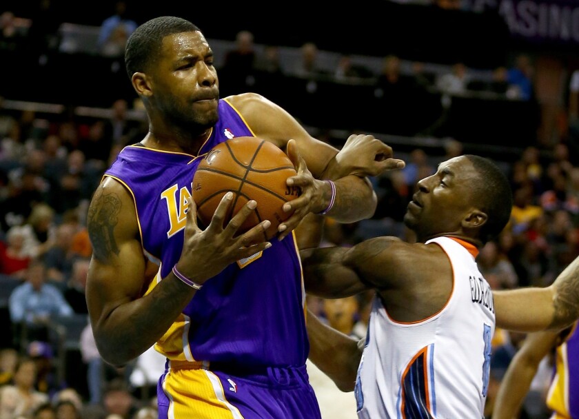 Lakers forward Shawne Williams tries to maintain possession of the ball during Saturday's 88-85 win over the Charlotte Bobcats.