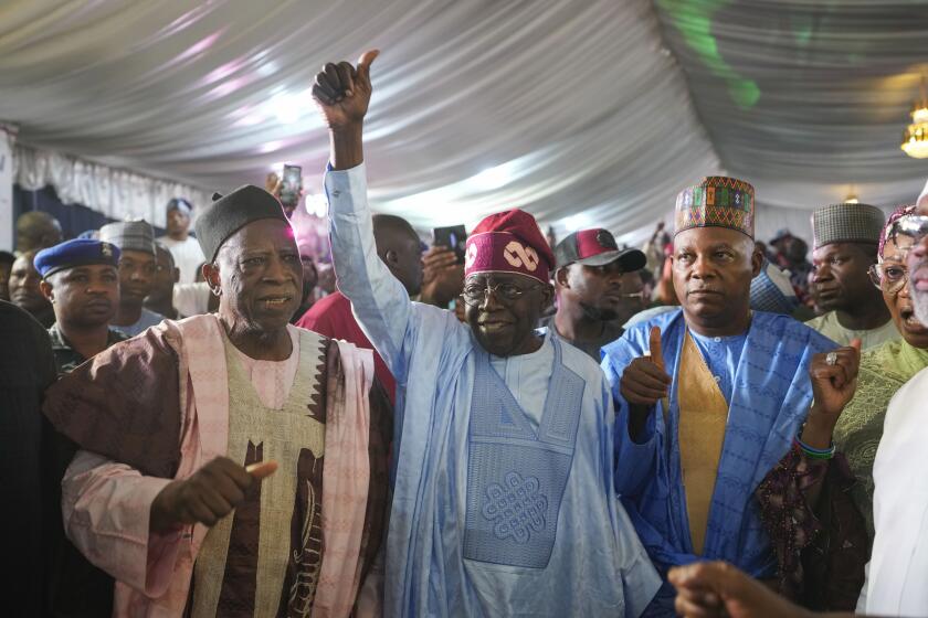 Bola Tinubu of the All Progressives Congress, center, celebrates with supporters at the party's campaign headquarters after winning the presidential elections in Abuja, Nigeria, Wednesday, March 1, 2023. Election officials declared ruling party candidate Tinubu the winner of Nigeria's presidential election with the two leading opposition candidates already demanding a re-vote in Africa's most populous nation. (AP Photo/Ben Curtis)