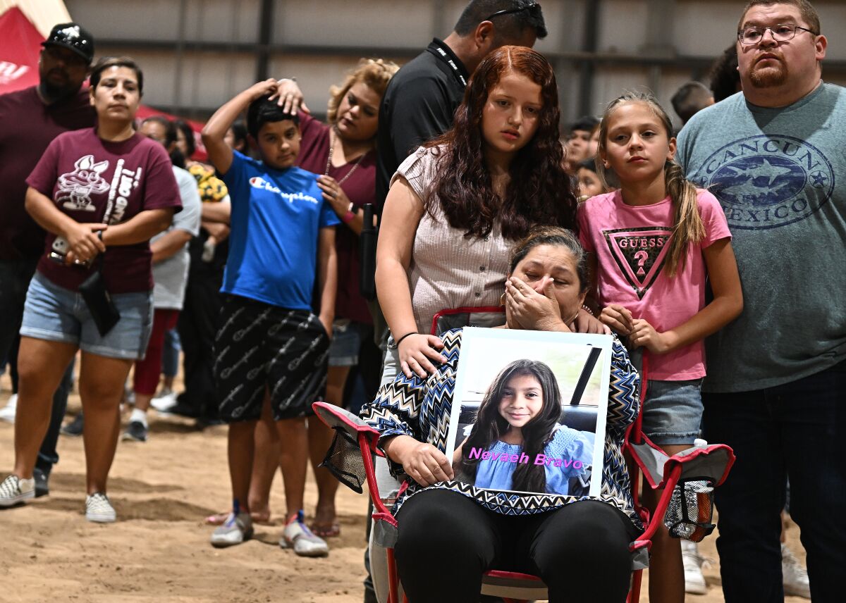 Esmeralda Bravo holds a picture of her granddaughter, one of the school shooting victims.