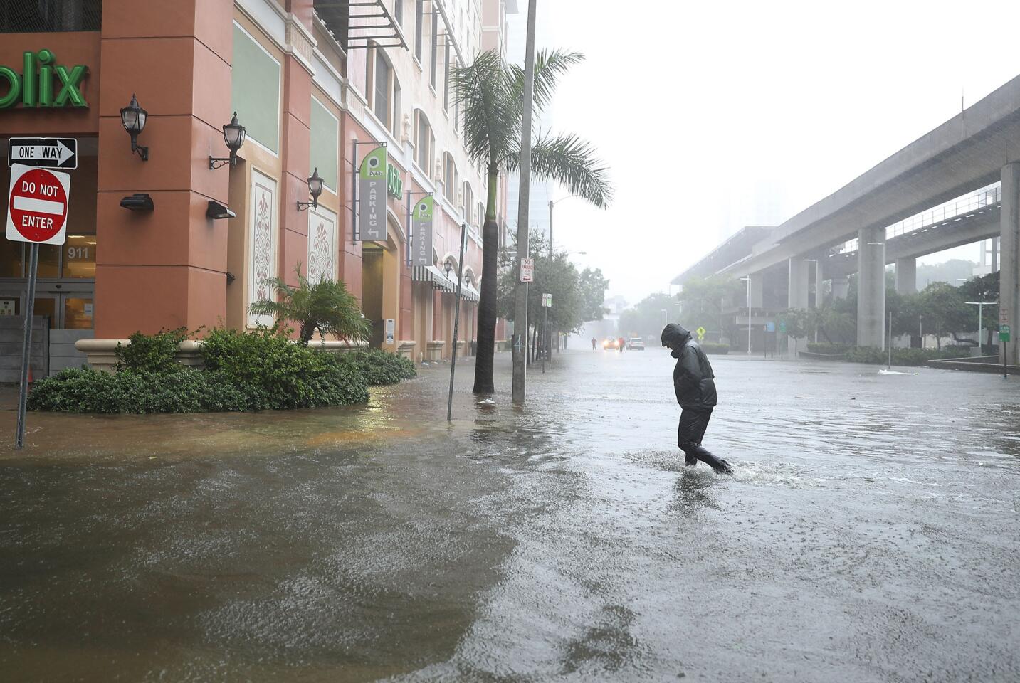 A person walks through a flooded street in the Brickell area of downtown Miami as Hurricane Irma passes through Sept. 10, 2017.