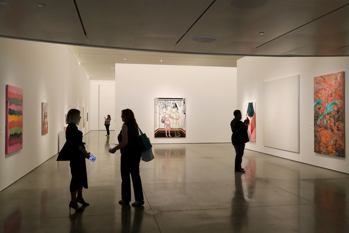 Visitors browse through the art exhibit "13 Women" at the Orange County Museum of Art in Costa Mesa.