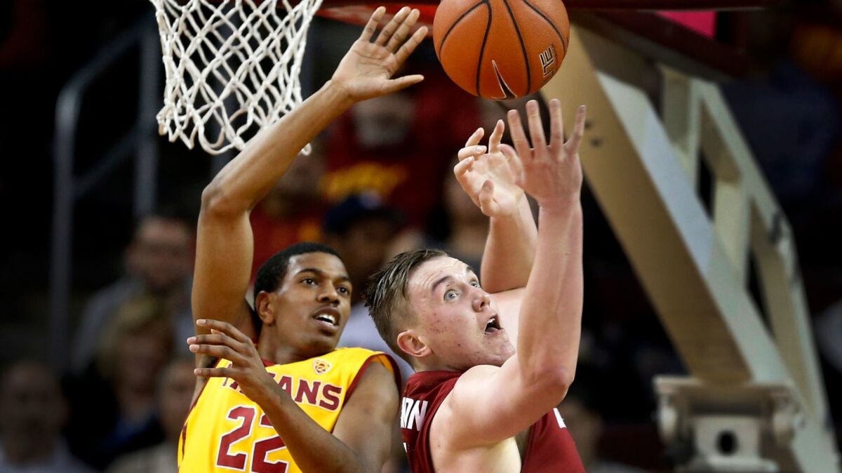 USC guard De'Anthony Melton, left, battles Washington State forward Josh Hawkinson for a rebound in a Pac-12 basketball game at the Galen Center on March 1.