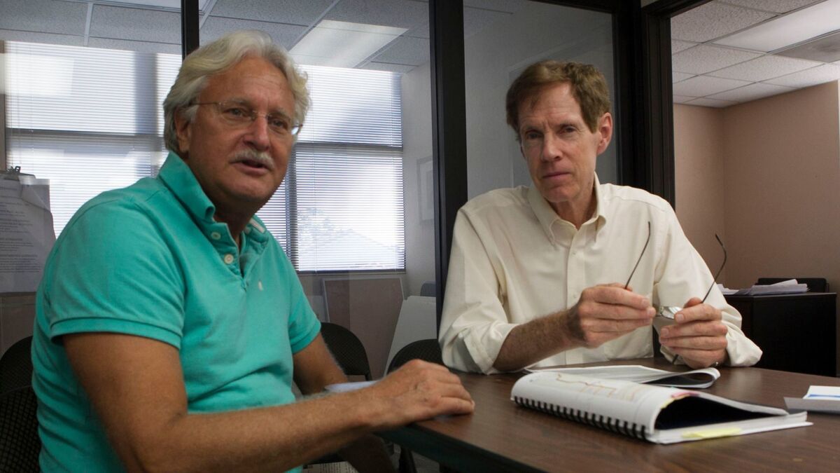 Uptown United founder Tom Mullaney and Roy Dahl in the group's office. (John Gibbins / Union-Tribune)