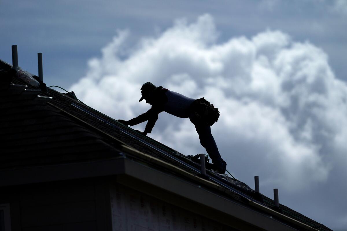 A roofer works on a home under construction in Houston on July 18.