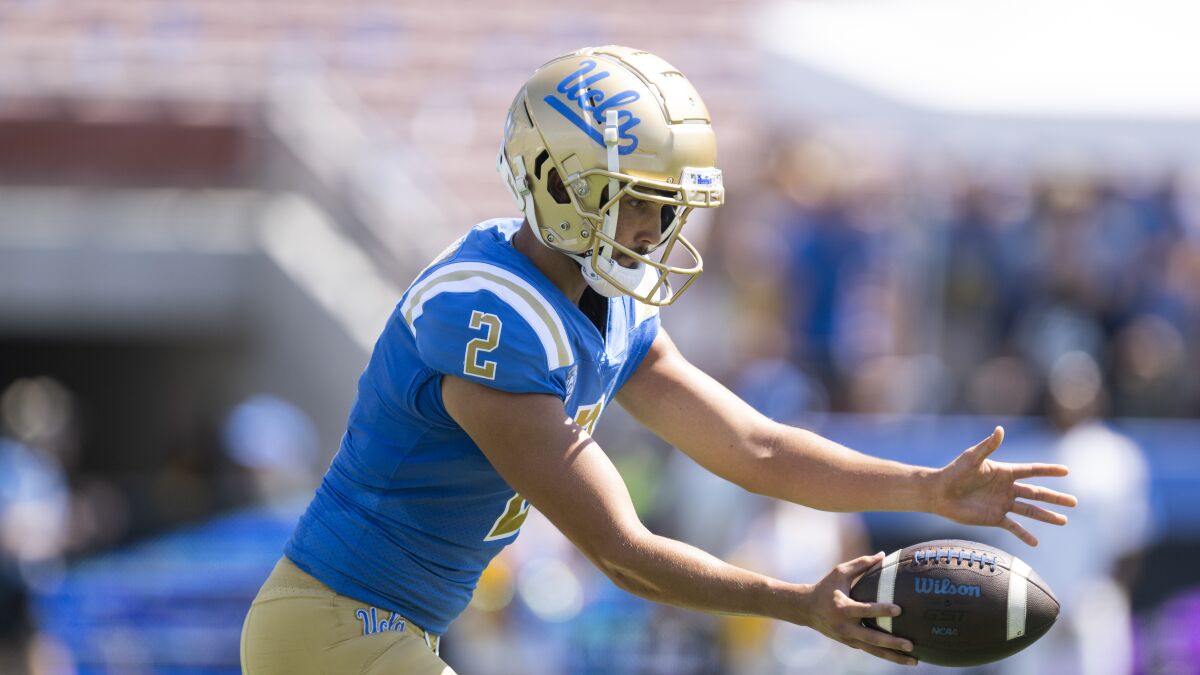 UCLA's Nicholas Barr-Mira looks down as he punts the ball against Bowling Green