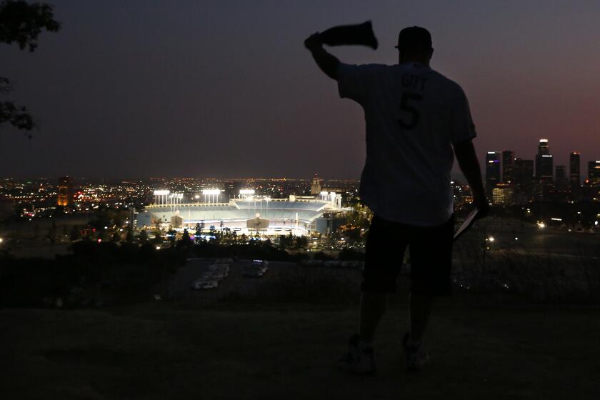 LOS ANGELES, CA - SEPTEMBER 30: Josh Gitt waves a bandana as the Dodgers in Game 1.