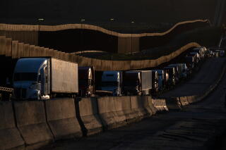Trucks queue near the Mexico-US border before crossing the border at Otay Commercial crossing in Tijuana