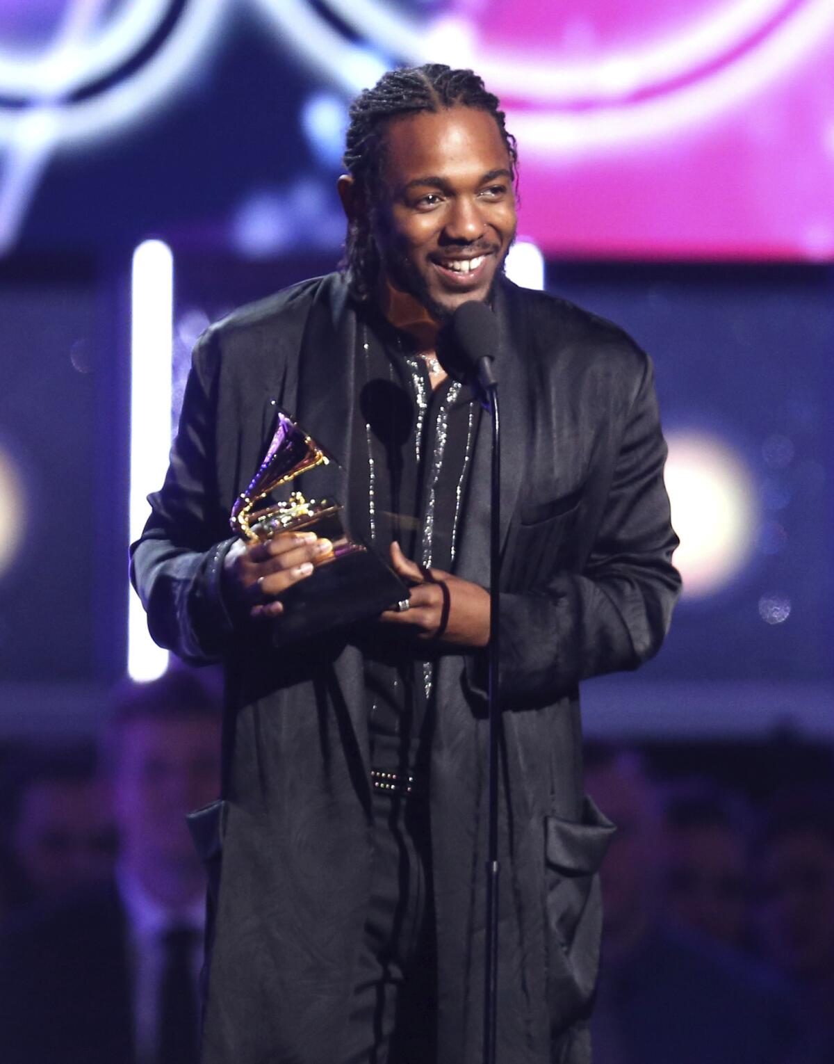 Kendrick Lamar accepts the award for rap album at Sunday's 60th Grammy Awards.