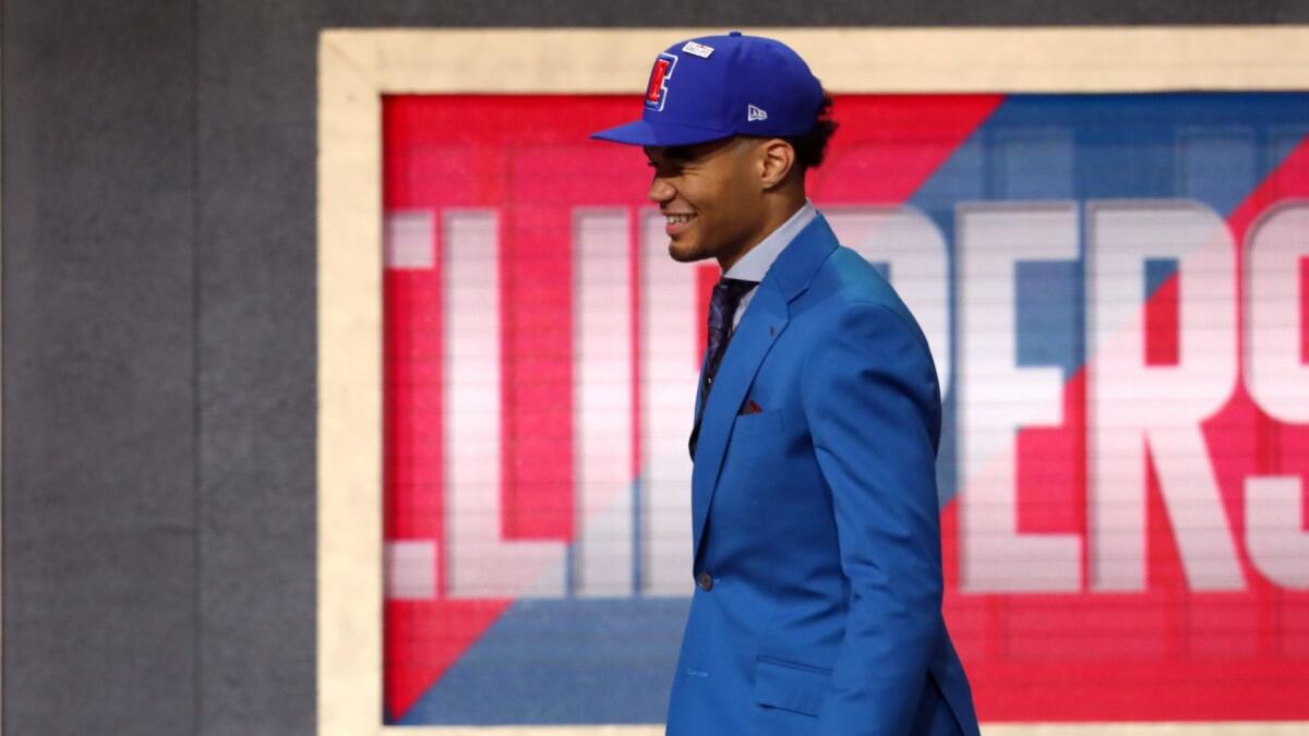 Jerome Robinson heads across the stage after getting selected 13th overall by the Clippers on Thursday night.