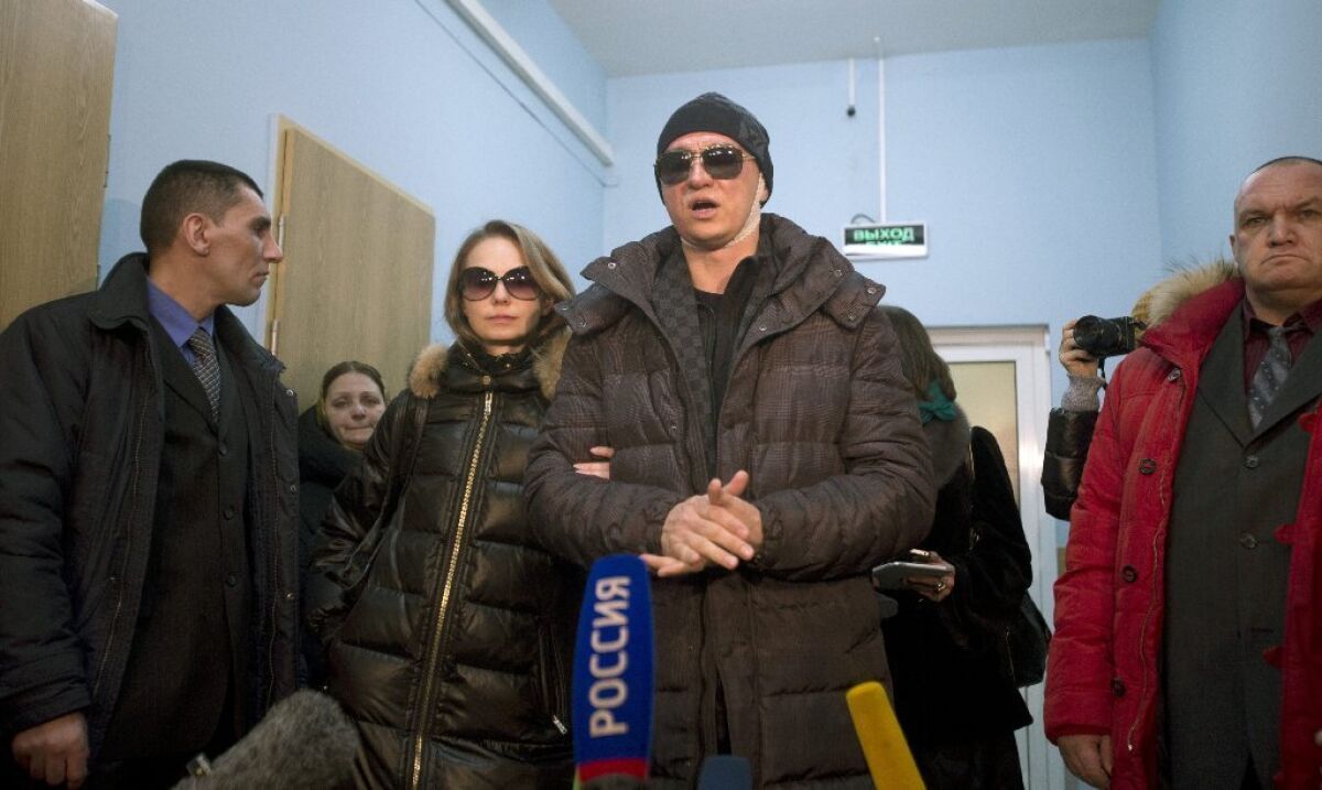 The Bolshoi Ballet's artistic director, Sergei Filin, speaks with reporters as he leaves a hospital in Moscow on Monday.