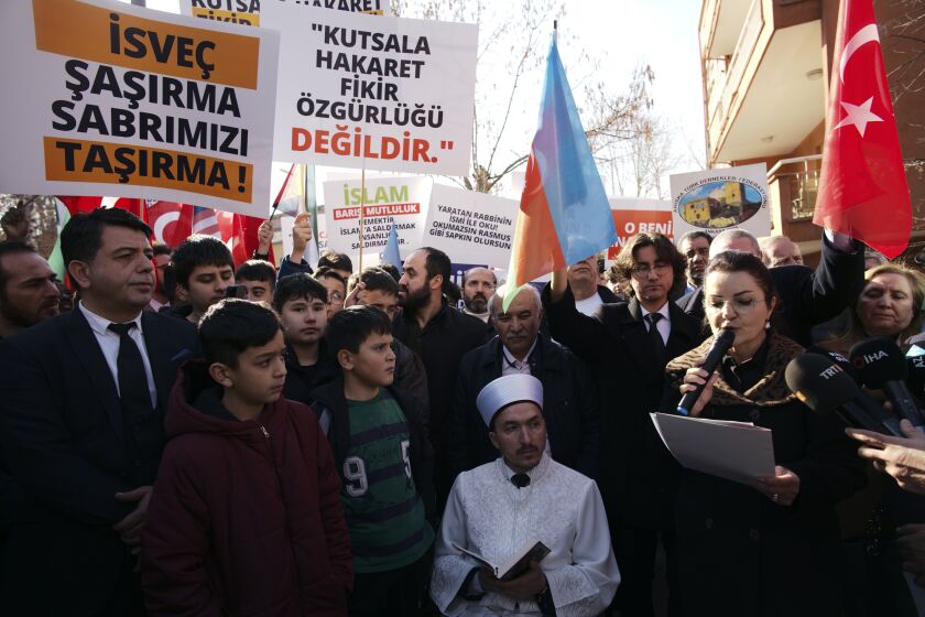 An Imam recites from the Quran, Islam's holy book, during a demonstration outside the Swedish embassy in Ankara, Turkey, Tuesday, Jan. 24, 2023. Outrage over a Quran-burning by a Danish-Swedish anti-Islam politician in Stockholm on Saturday caused protests in Turkey, reflecting tensions between the two countries. (AP Photo/Burhan Ozbilici)