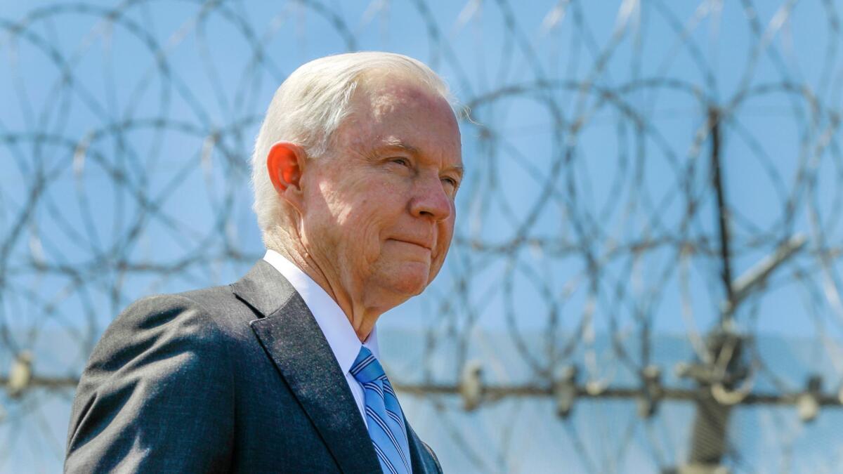 U.S. Atty. Gen. Jeff Sessions stands near a secondary border fence in San Diego on April 21, 2017.