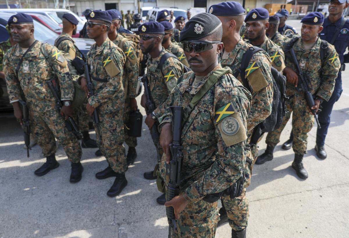 Policías jamaicanos montan guardia en la pista del Aeropuerto Internacional Toussaint