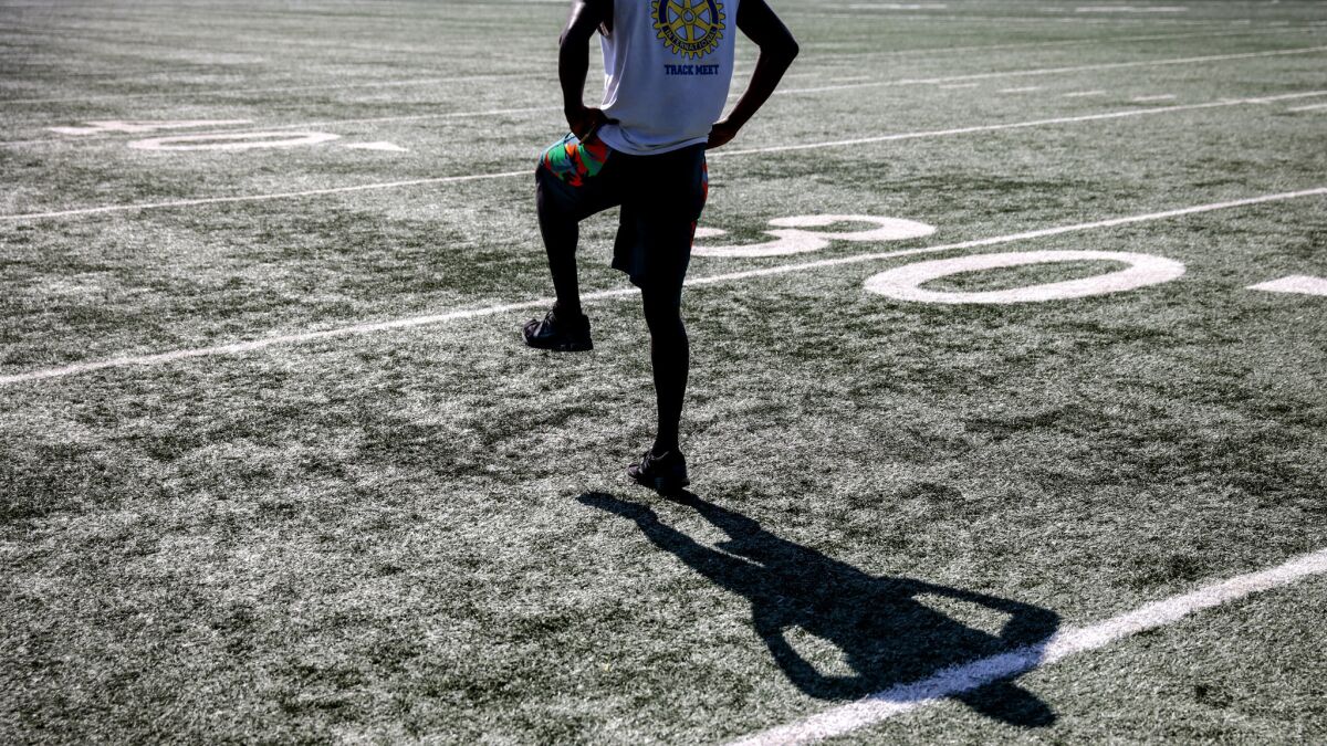 Arshaad Rahh, who competes for Cal State University Northridge in track and field, warms up on the artificial turf field at Rancho Cienega Recreation Center in Los Angeles.