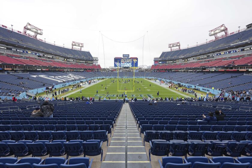 A stadium view of Tennessee Titans' Nissan Stadium as fans begin to arrive before an NFL football game against the ,Jacksonville Jaguars, Dec. 11, 2022, in Nashville, Tenn. The Titans are tearing up the grass and replacing the field with a synthetic surface before the 2023 season. The Titans announced the change Tuesday, Jan. 31, 2023. (AP Photo/Peter Joneleit)