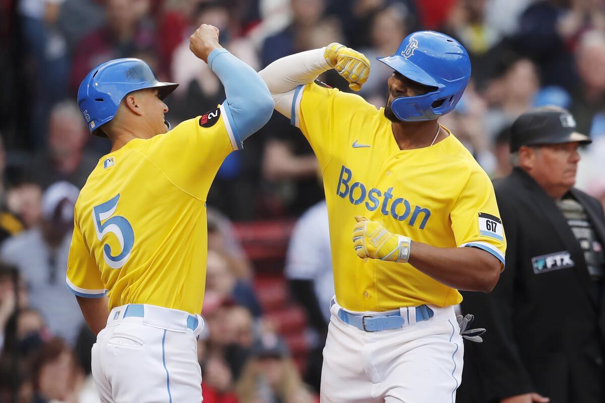 Boston Red Sox's Bobby Dalbec celebrates with Enrique Hernandez