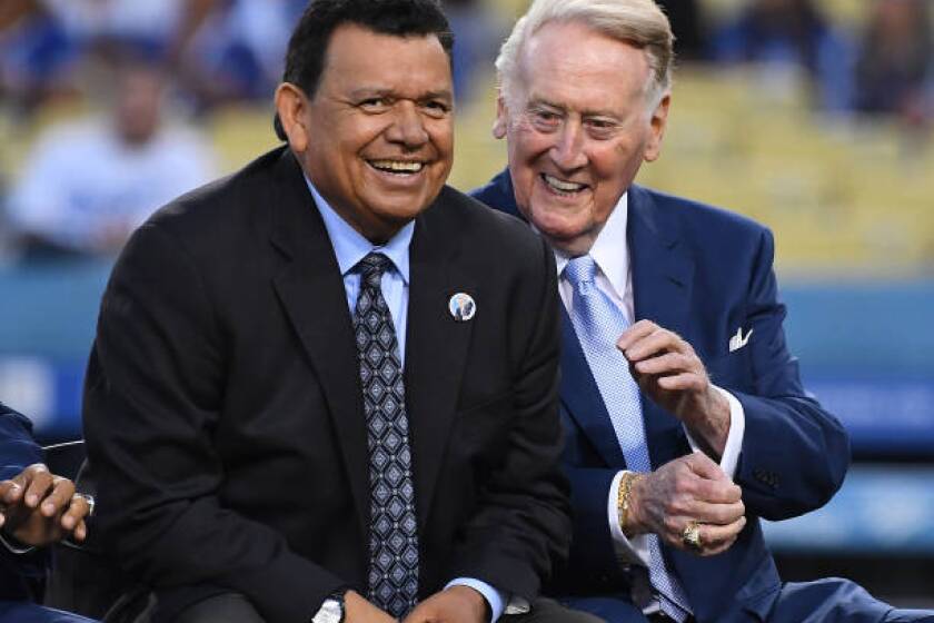 LOS ANGELES, CA - SEPTEMBER 21: Retired Los Angeles Dodgers broadcaster Vin Scully, left, jokes with Spanish language broadcaster Fernando Valenzuela duirng a pregame ceremony inducting veteran Spanish language broadcaster Jaime Jarrin into the Dodger Stadium Ring of Honor at Dodger Stadium on September 2, 2018 in Los Angeles, California. (Photo by Jayne Kamin-Oncea/Getty Images)
