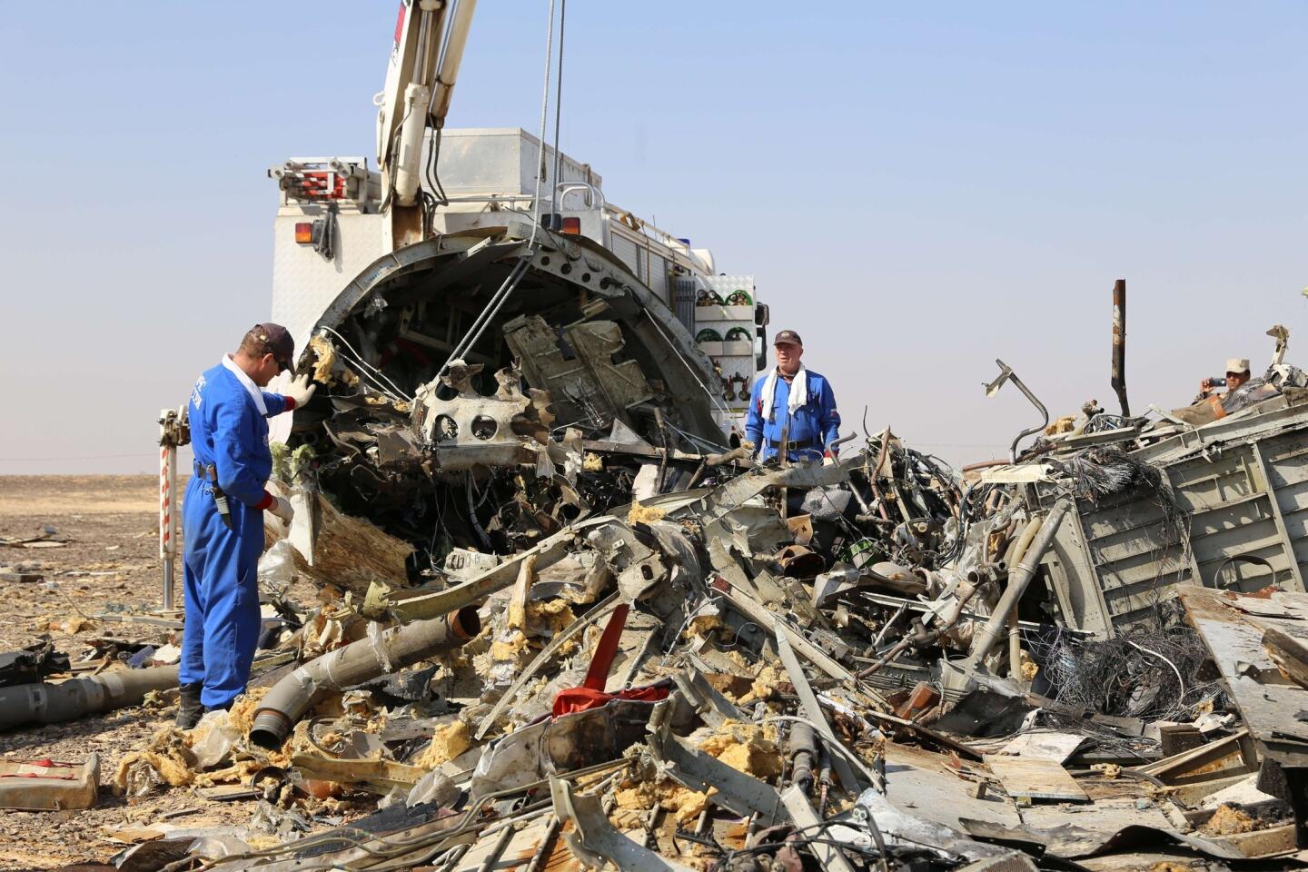 Russian emergency services personnel at the crash site of a A321 Russian airliner in Wadi al-Zolomat, a mountainous area of Egypt's Sinai Peninsula.