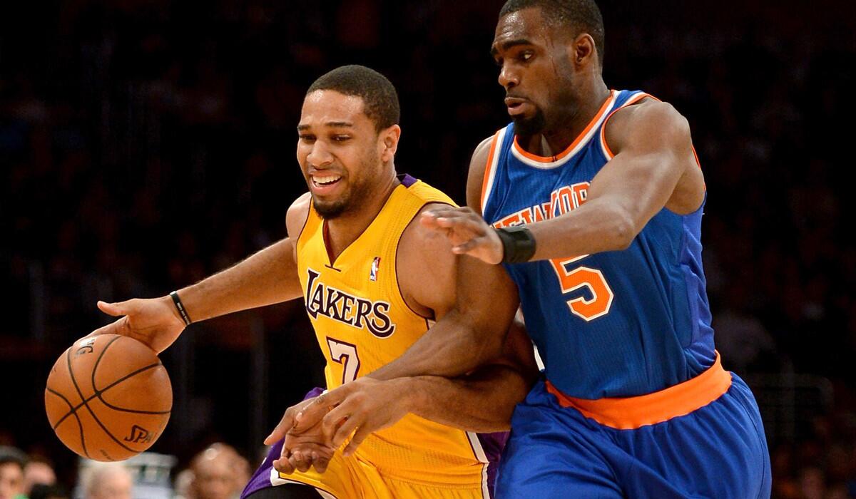 Lakers swingman Xavier Henry drives against Knicks guard Tim Hardaway Jr. during a game last season.