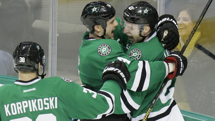Stars defenseman Esa Lindell, right, is congratulated by teammates Jamie Benn and Lauri Korpikoski after scoring against the Kings in overtime Friday night.