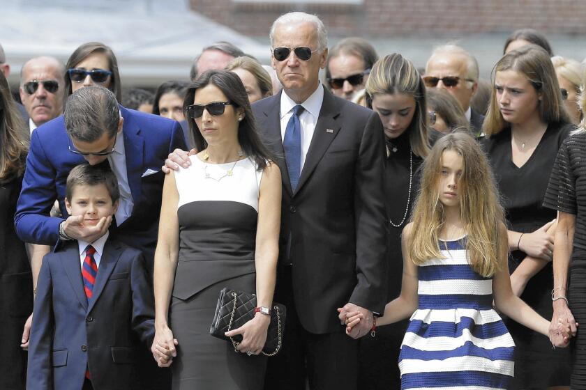 Vice President Joe Biden, center, before son Beau’s funeral in June, with family members including Beau’s widow, Hallie, and children Hunter and Natalie, in front.