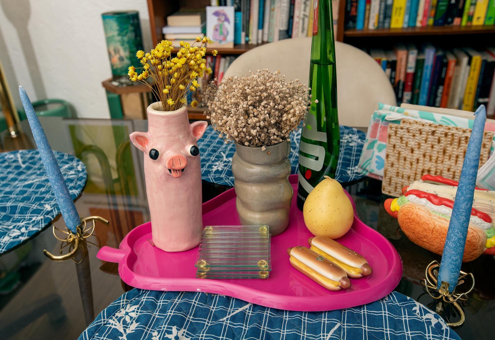 Vases and other household decorations on a dining room table.