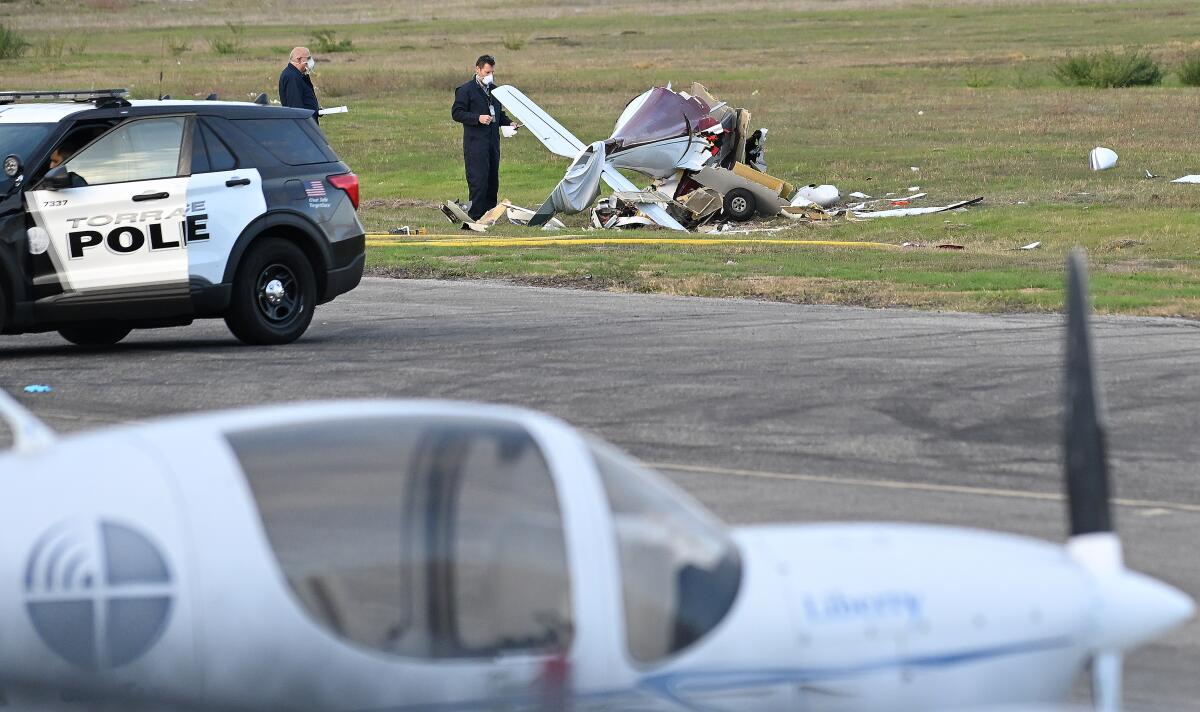 Investigators look over a plane that crashed and killed two people 
