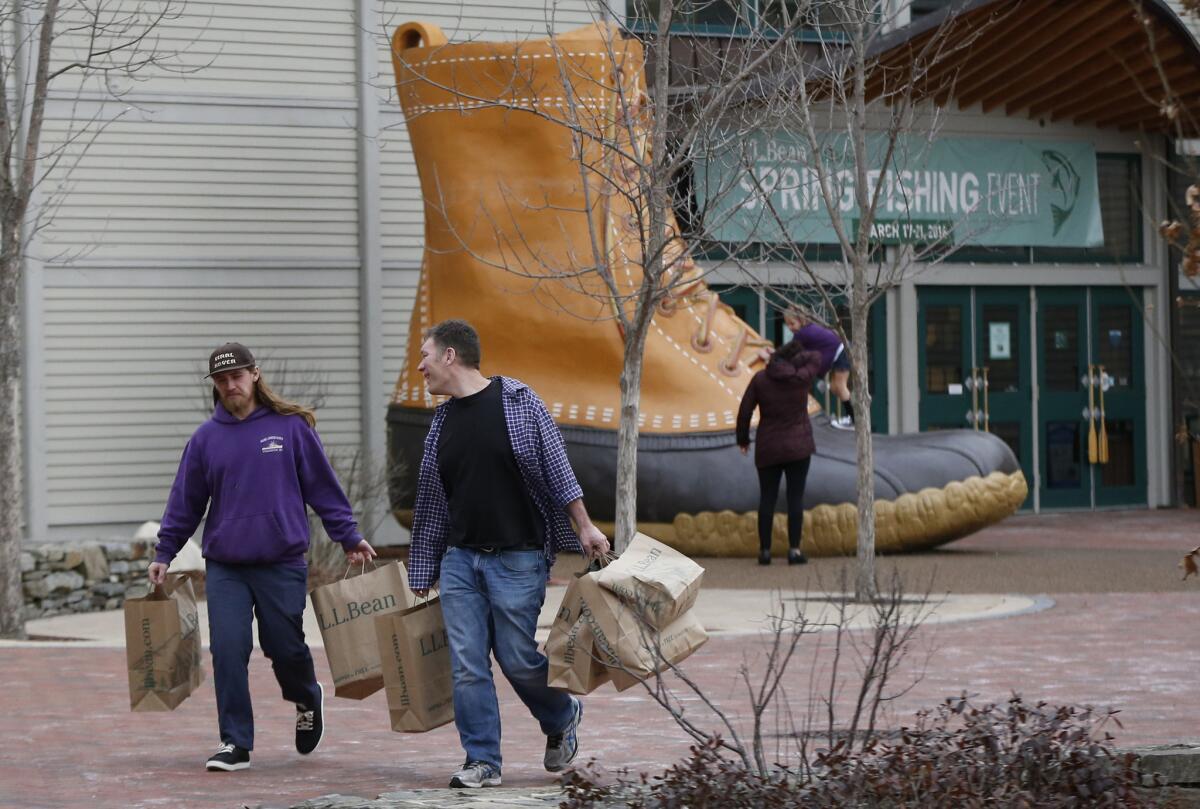 Shoppers leave the L.L. Bean retail store in Freeport, Maine, on March 16.