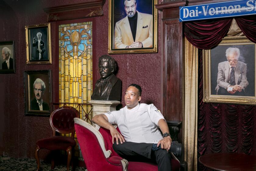 HOLLYWOOD, CALIFORNIA - June 11, 2019: The Magic Castle's new executive chef Jason Fullilove poses for a portrait on Tuesday, June 11, 2019, underneath the portraits of famous magicians at the 55-year-old private club in Hollywood. (Silvia Razgova / For The Times) 3082342_la-fo-magic-castle