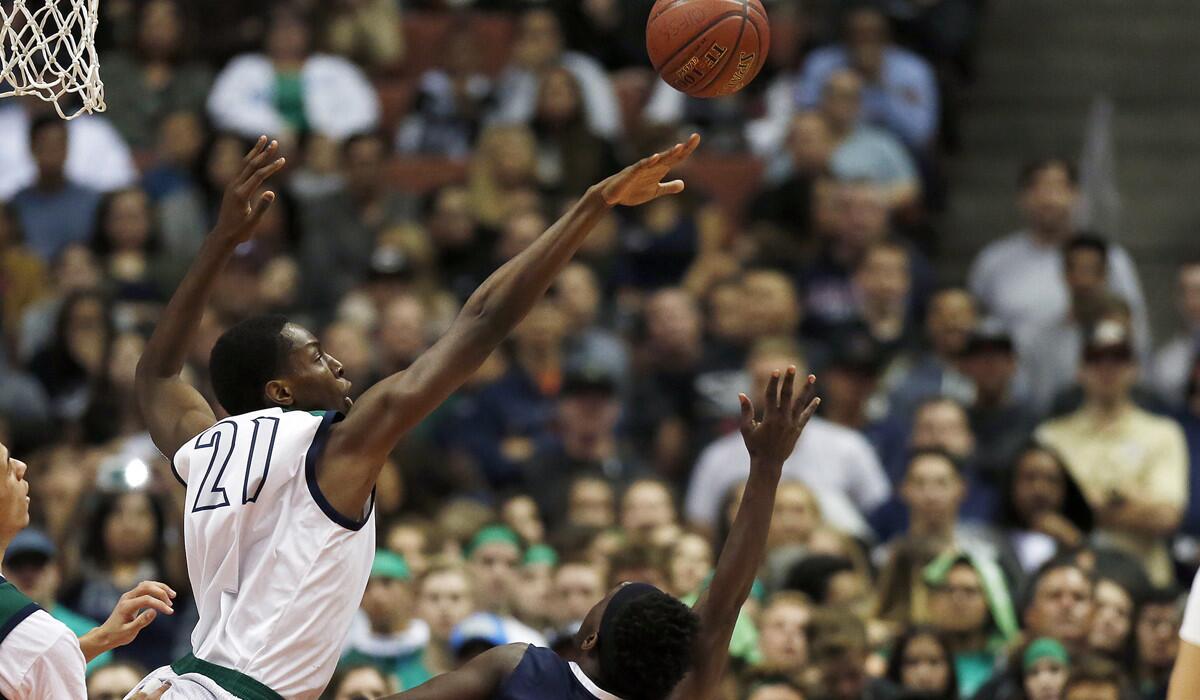 Chino Hills Onyeka Okongwu (21) goes for the block on Sierra Canyon Devearl Ramsey during the CIF Southern Section Championships at Honda Center on March 5.