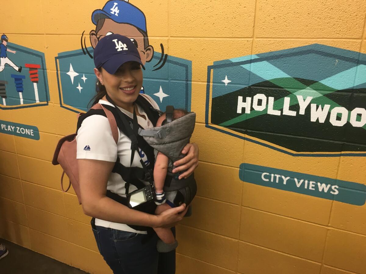 Maria Aguilar and her baby at Game 3 of the World Series.