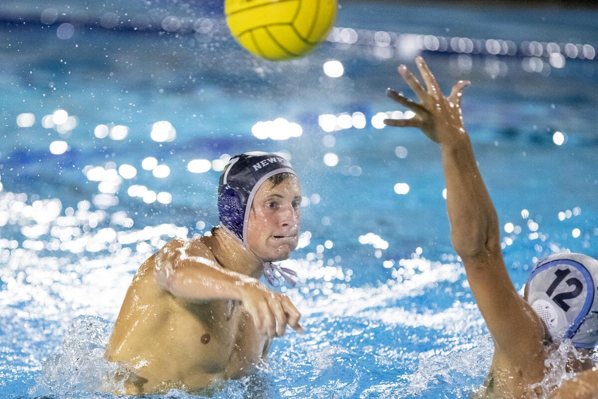 Newport Harbor's Mason Hunt takes a shot under pressure from CdM's Charles Warmington during the Battle of the Bay Wednesday.