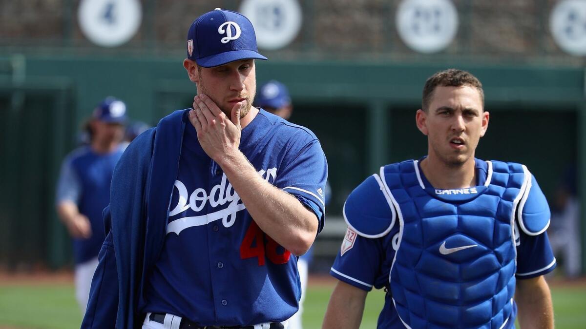 Dodgers pitcher Brock Stewart and catcher Austin Barnes walk to the dugout before a game against the Cubs on Feb. 25.