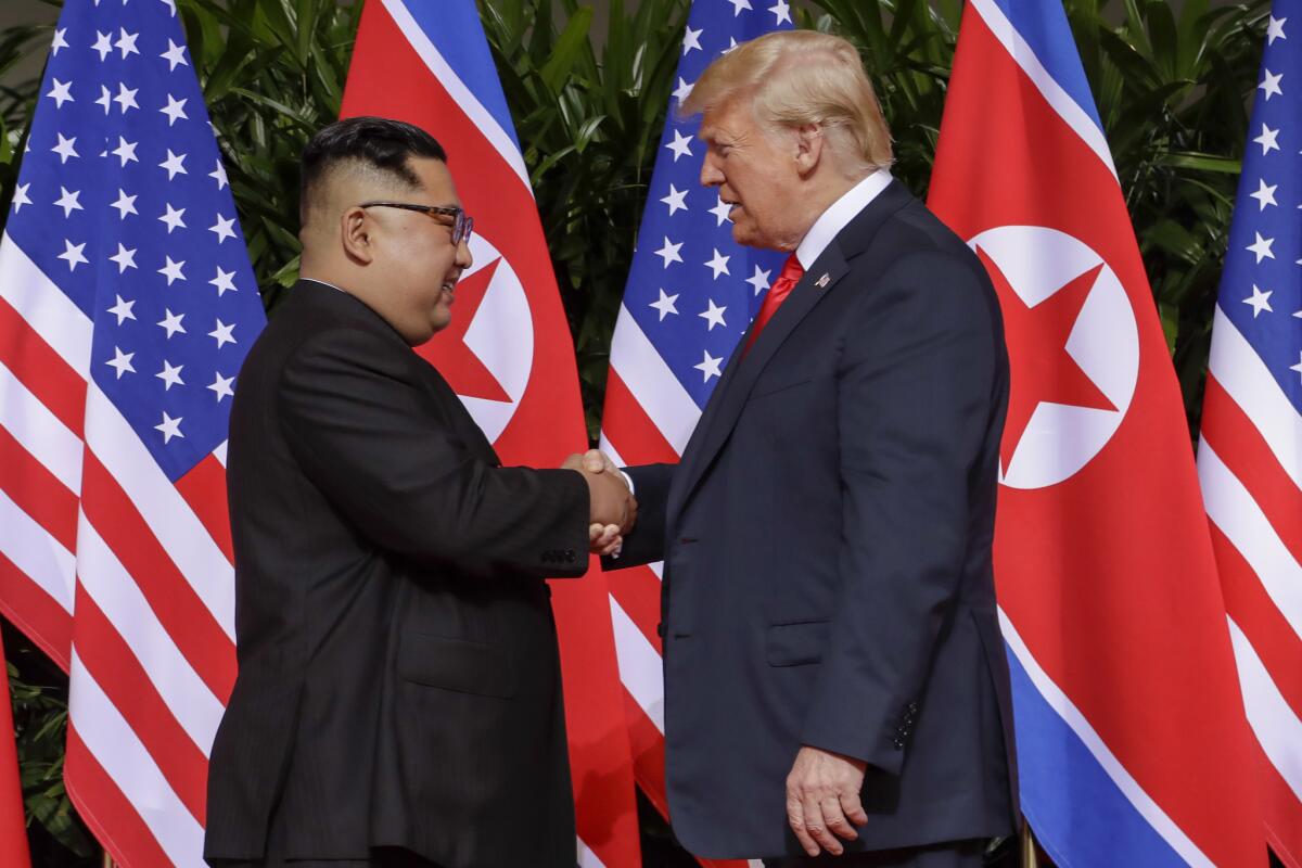 President Trump shakes hands with North Korean leader Kim Jong Un, left, on Sentosa Island in Singapore.