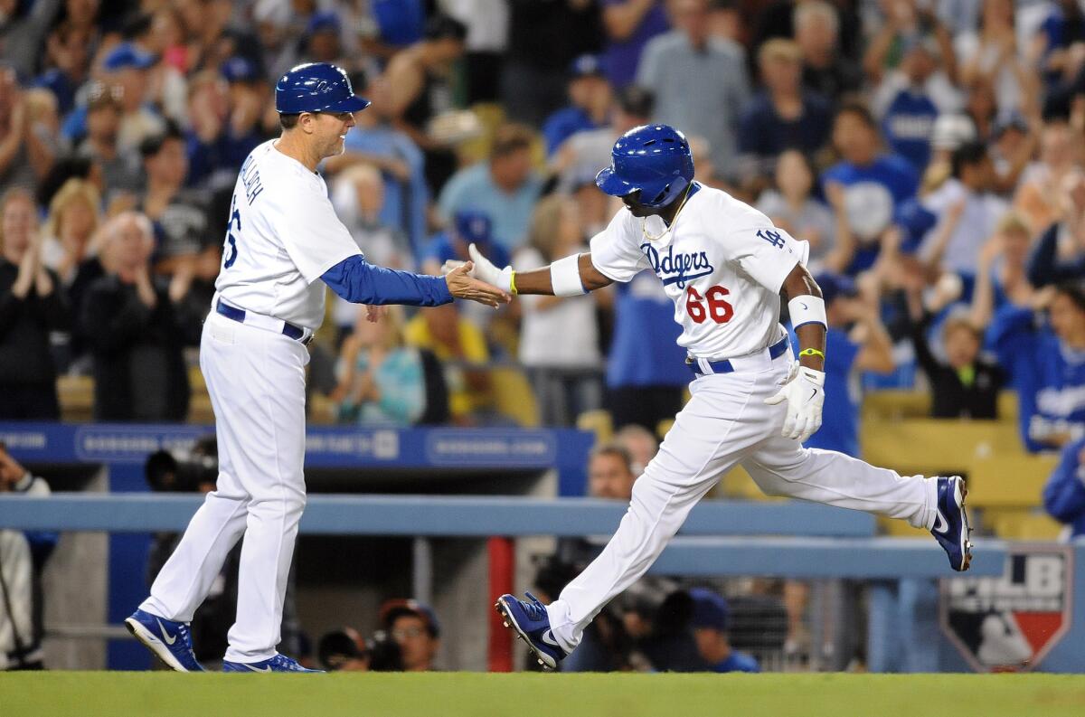 Dodgers Bench Coach Tim Wallach, left, hopes the offensive production picks up with Yasiel Puig (66) back in the lineup.