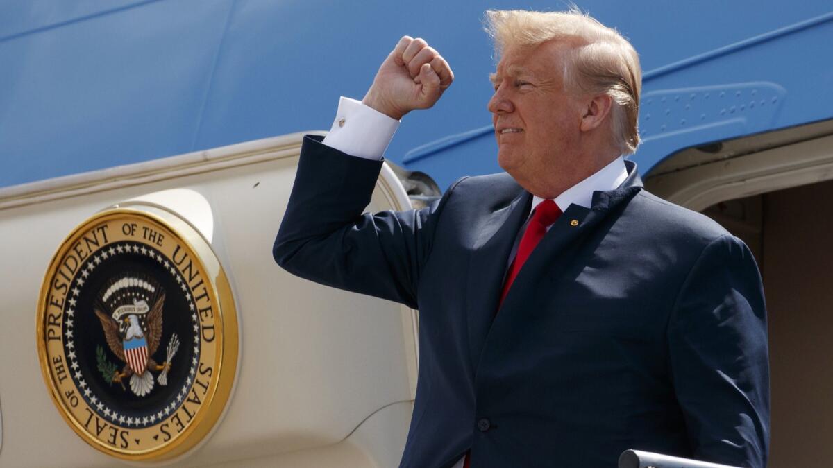 President Trump pumps his fist as he steps off Air Force One on May 31, 2018, in Houston.