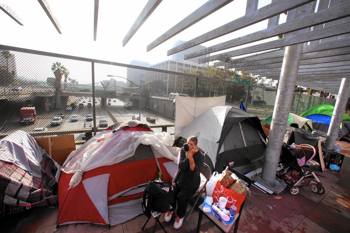 Homeless camps near L.A. freeways, like the site Alena has staked above the 101 downtown, are on the rise. “I’m new to this unexpected homelessness,” says the 45-year-old, who was laid off from her job as an administrative assistant early this year.
