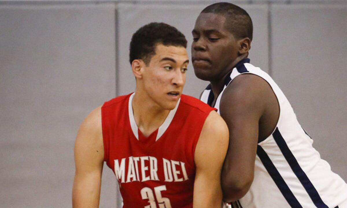Mater Dei sophomore M.J. Cage, left, is guarded by Mayfair junior Kendall Smith during the Monarchs' win in the Southern Section Open Division quarterfinals on Friday.