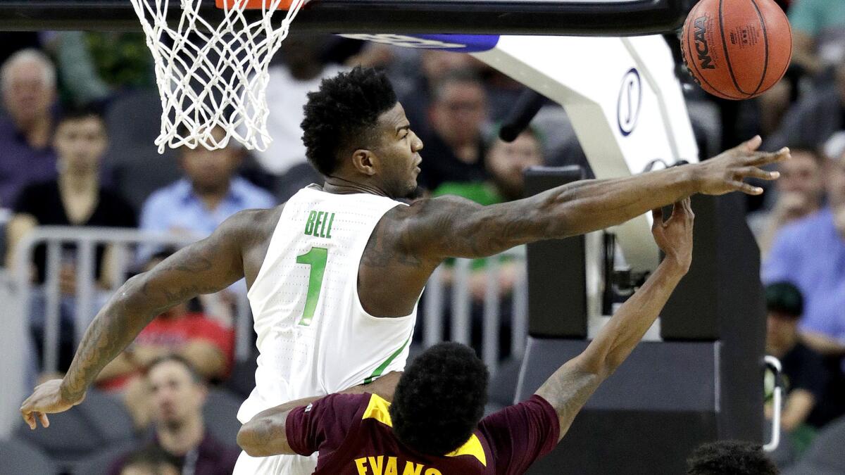 Oregon forward Jordan Bell tries to block a shot by Arizona State guard Shannon Evans II during the first half Thursday.