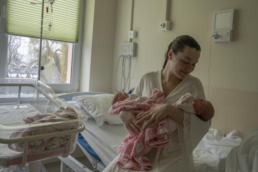 Woman holding newborn twins