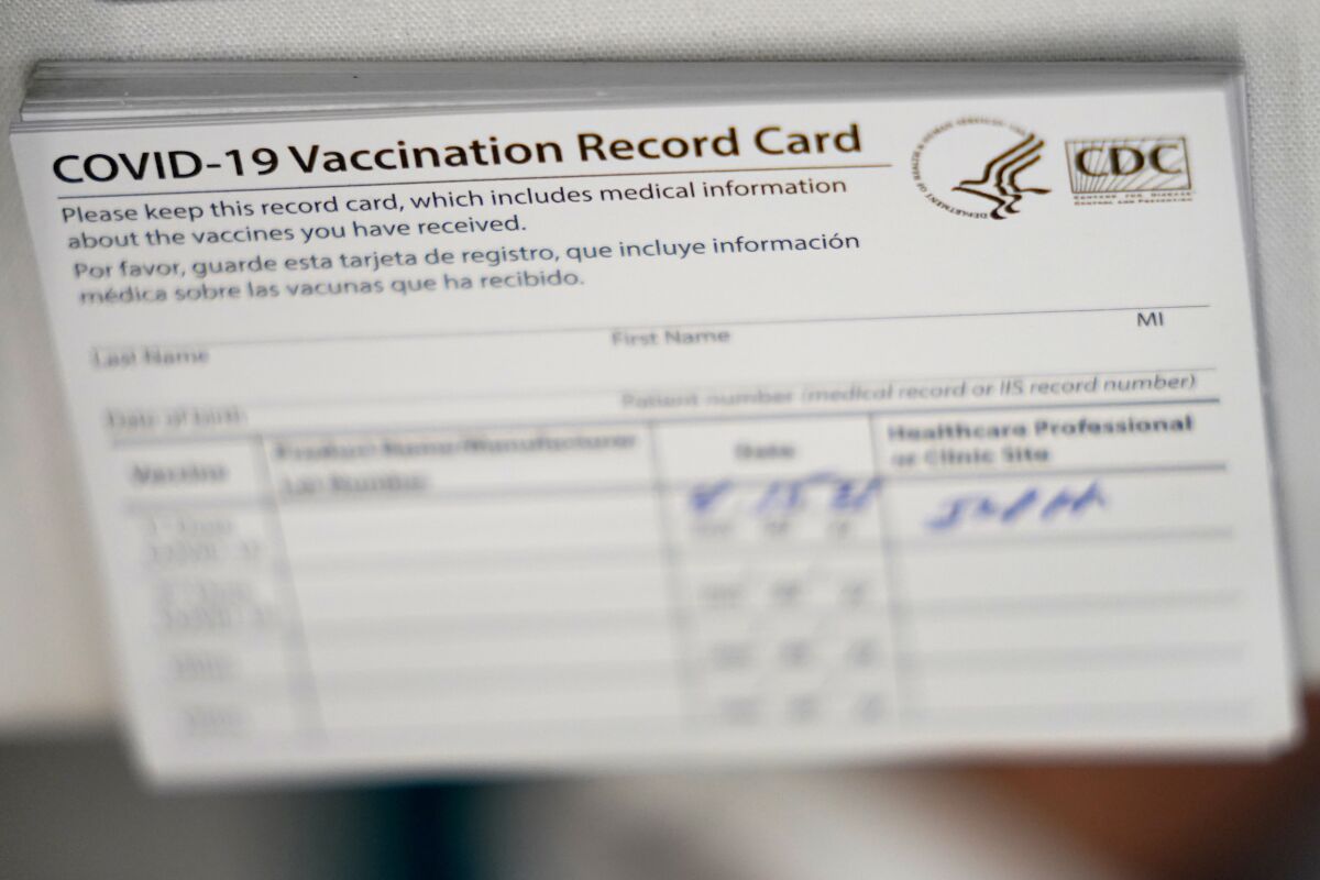 A stack of CDC coronavirus COVID-19 vaccination cards.