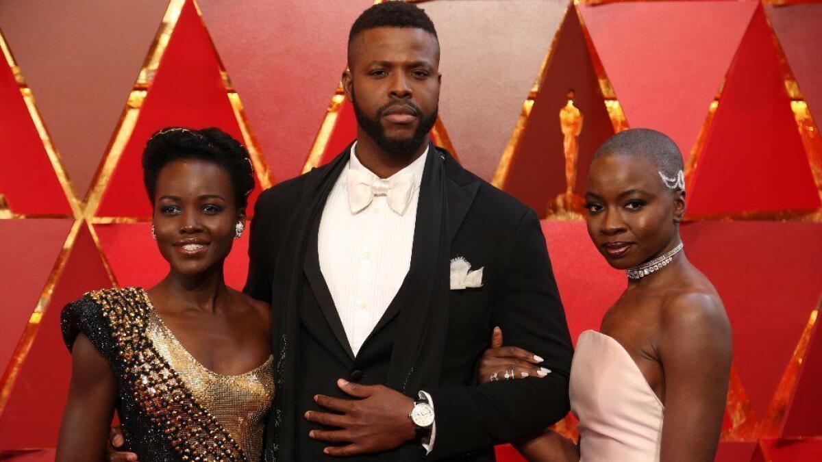 Winston Duke, center, was invited to join his "Black Panther" co-stars Lupita Nyong'o, left, and Danai Gurira as members of the Academy of Motion Picture Arts and Sciences.